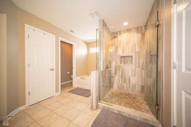 bathroom featuring visible vents, toilet, a stall shower, baseboards, and a bath