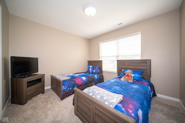 carpeted bedroom featuring visible vents and baseboards