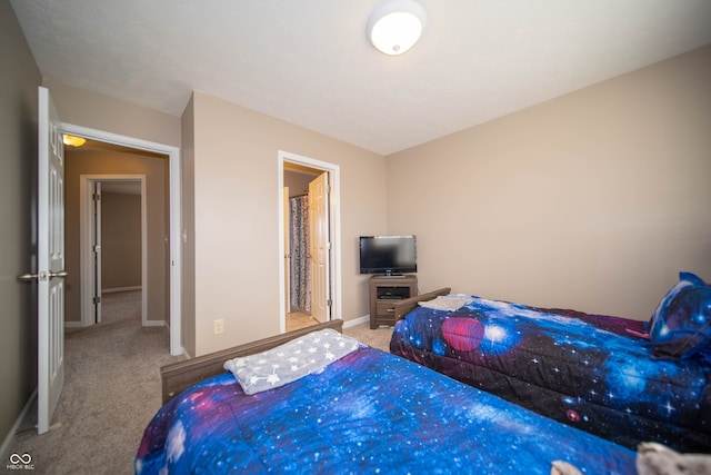 bedroom with baseboards and carpet