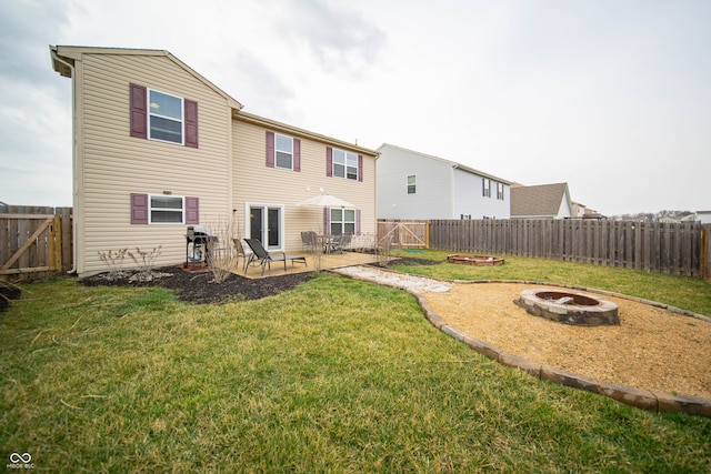 rear view of property with a patio area, a lawn, an outdoor fire pit, and a fenced backyard