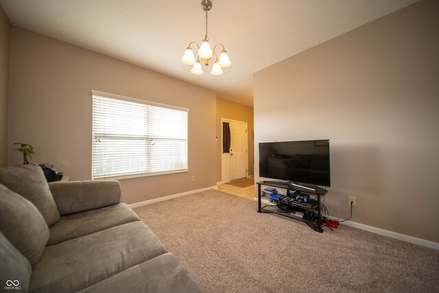 carpeted living area featuring baseboards and a chandelier