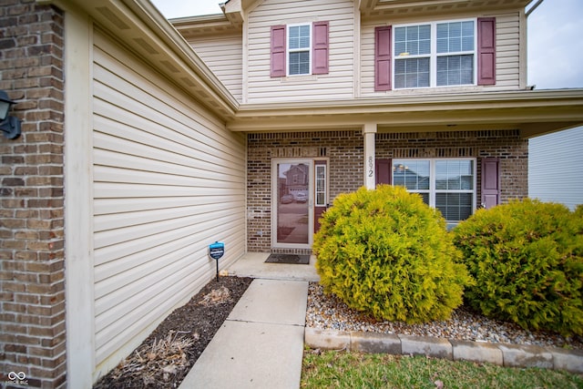 doorway to property with brick siding