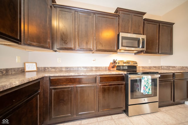 kitchen featuring dark brown cabinetry and stainless steel appliances