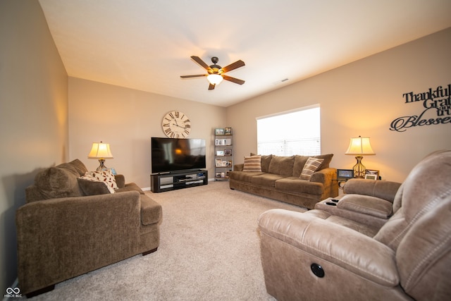 carpeted living area featuring visible vents and a ceiling fan