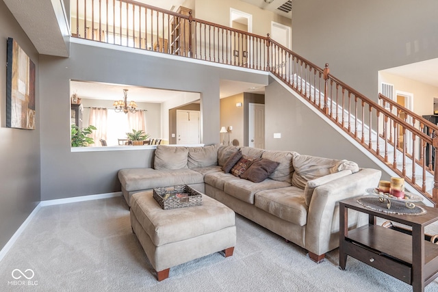 carpeted living room featuring visible vents, baseboards, a chandelier, stairs, and a towering ceiling