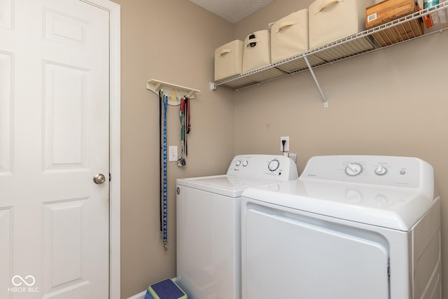 clothes washing area featuring laundry area and separate washer and dryer