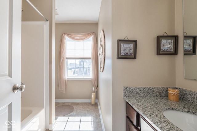 full bathroom with tile patterned floors, a washtub, baseboards, walk in shower, and vanity