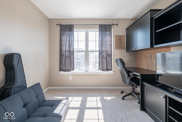 home office with baseboards and light carpet