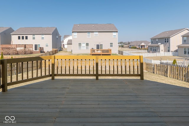 wooden deck with a fenced backyard and a residential view