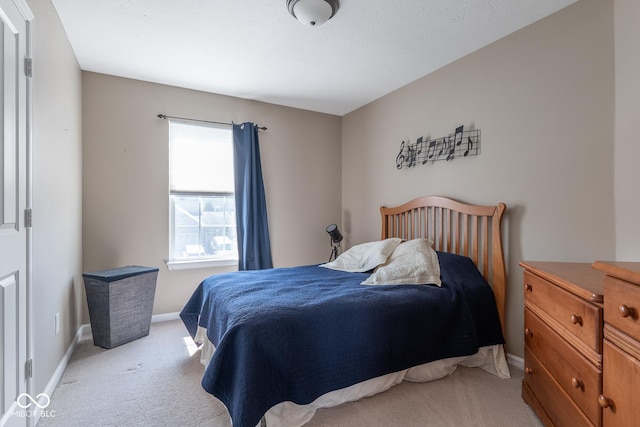 bedroom featuring light colored carpet and baseboards