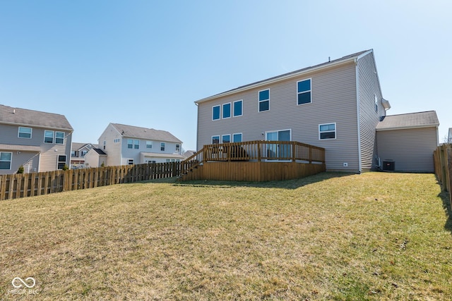 rear view of house with a yard, a deck, a fenced backyard, and central air condition unit