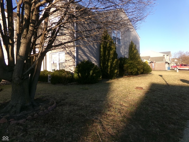 view of side of home with a lawn