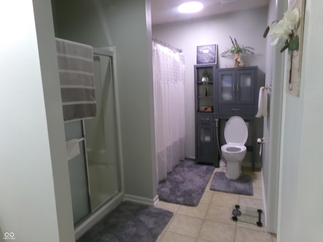 full bathroom featuring tile patterned flooring, a shower stall, and toilet