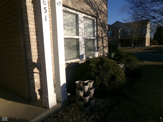 view of side of property featuring brick siding