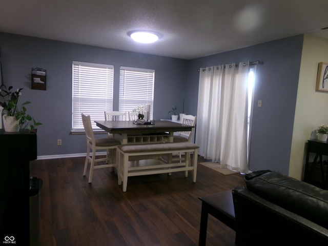 dining room with dark wood-style floors and baseboards