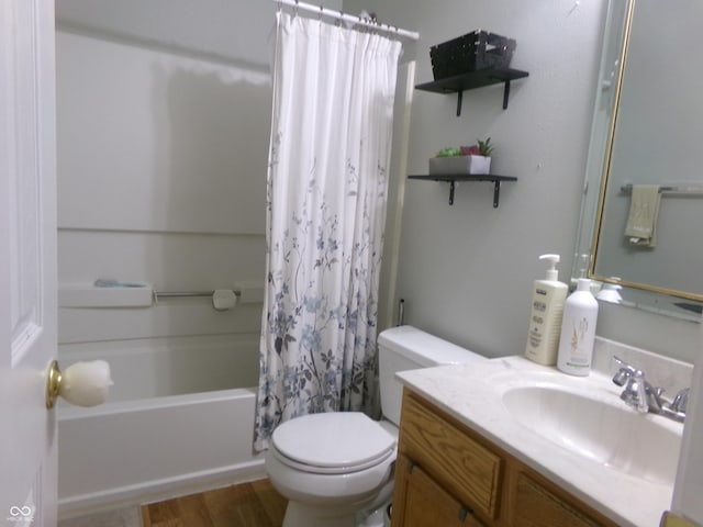 bathroom featuring wood finished floors, toilet, shower / tub combo with curtain, and vanity