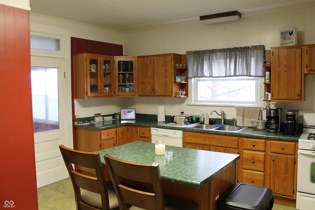 kitchen featuring white appliances, brown cabinetry, a breakfast bar, open shelves, and a sink