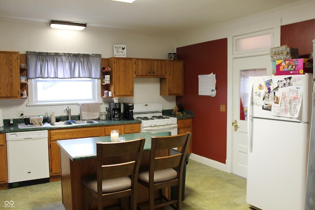 kitchen featuring a sink, open shelves, dark countertops, white appliances, and brown cabinetry