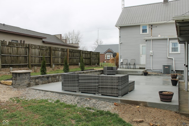 exterior space with central AC unit, an outdoor hangout area, and a fenced backyard