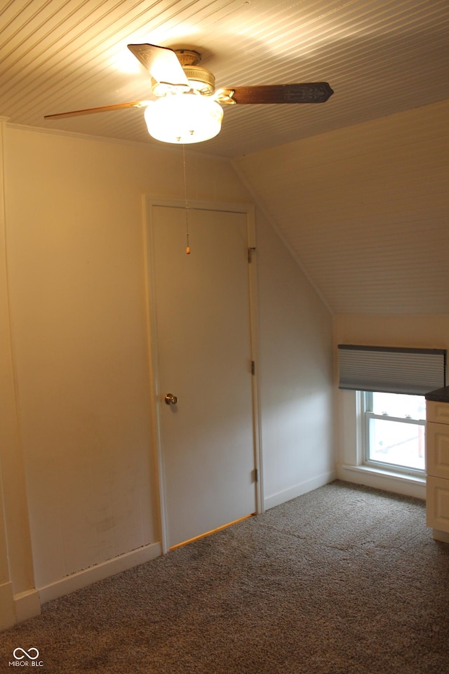 additional living space with lofted ceiling, carpet, and a ceiling fan