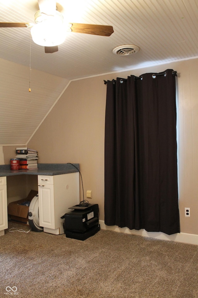 interior space with visible vents, lofted ceiling, ceiling fan, wooden ceiling, and dark colored carpet