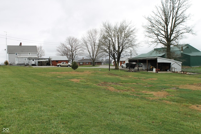 view of yard with an outbuilding and a pole building