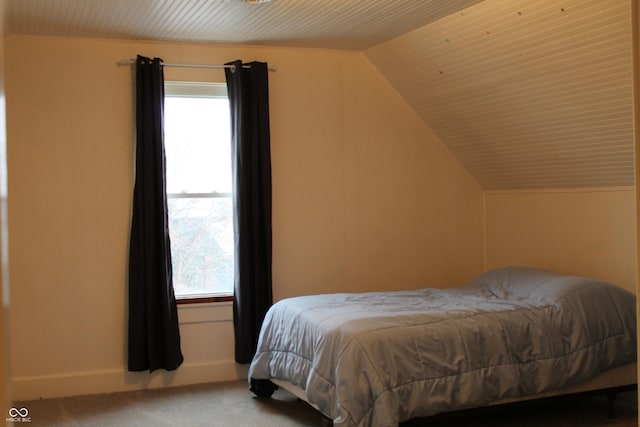 carpeted bedroom with vaulted ceiling