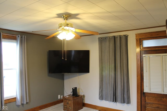 interior space featuring baseboards and a ceiling fan