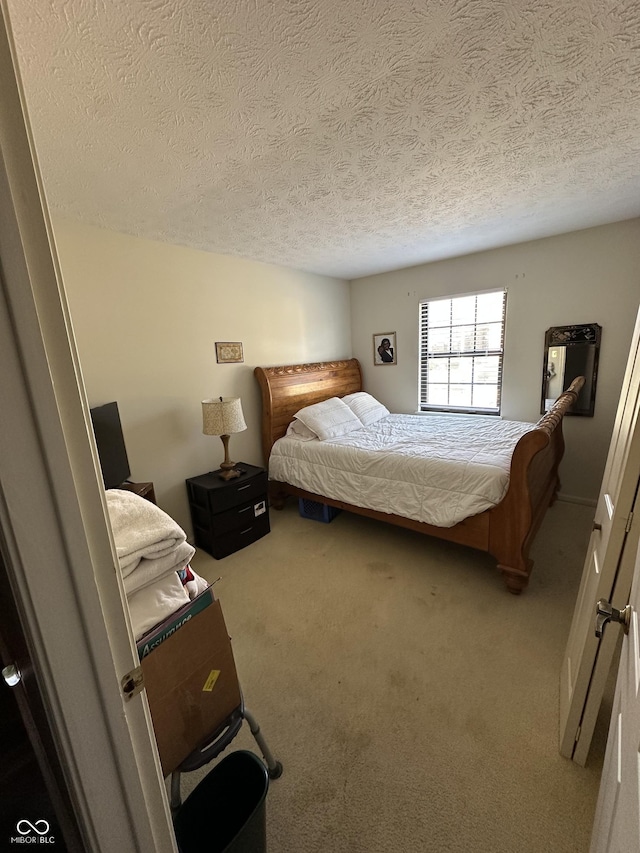carpeted bedroom featuring a textured ceiling