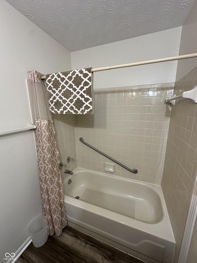 full bathroom with shower / bathtub combination with curtain, wood finished floors, and a textured ceiling