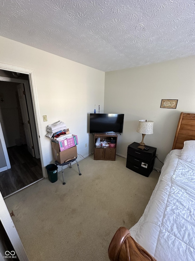 carpeted bedroom featuring a textured ceiling