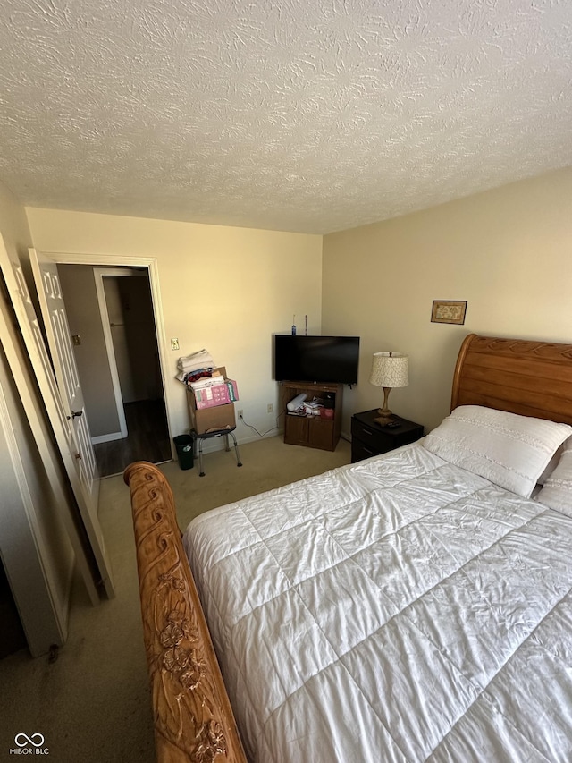 bedroom with carpet and a textured ceiling