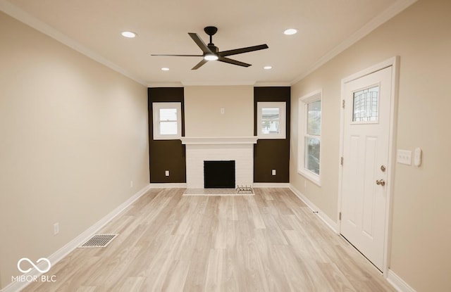4504 Winthrop Ave, Indianapolis, IN 46205 - unfurnished living room featuring visible vents, light wood-type flooring, baseboards, a fireplace, and ceiling fan