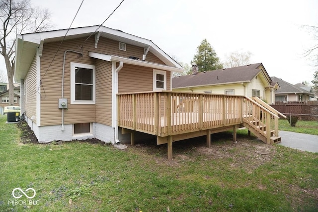 4504 Winthrop Ave, Indianapolis, IN 46205 - back of property featuring a wooden deck, cooling unit, a lawn, and fence