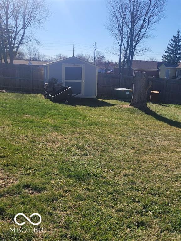 4930 Candy Spots Dr, Indianapolis, IN 46237 - fenced backyard featuring a storage unit