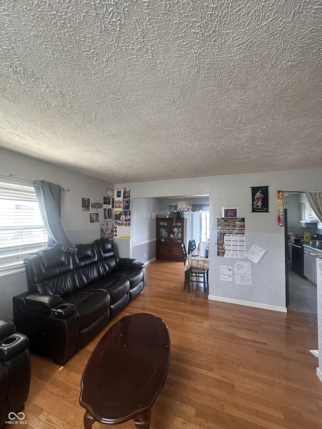 4930 Candy Spots Dr, Indianapolis, IN 46237 - living room featuring a textured ceiling, a chandelier, and wood finished floors