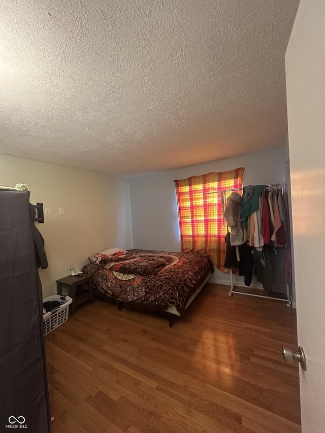 4930 Candy Spots Dr, Indianapolis, IN 46237 - bedroom with a textured ceiling and wood finished floors
