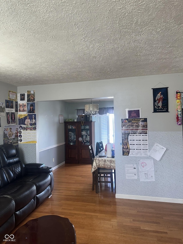 4930 Candy Spots Dr, Indianapolis, IN 46237 - living room with a textured ceiling, wood finished floors, and a chandelier