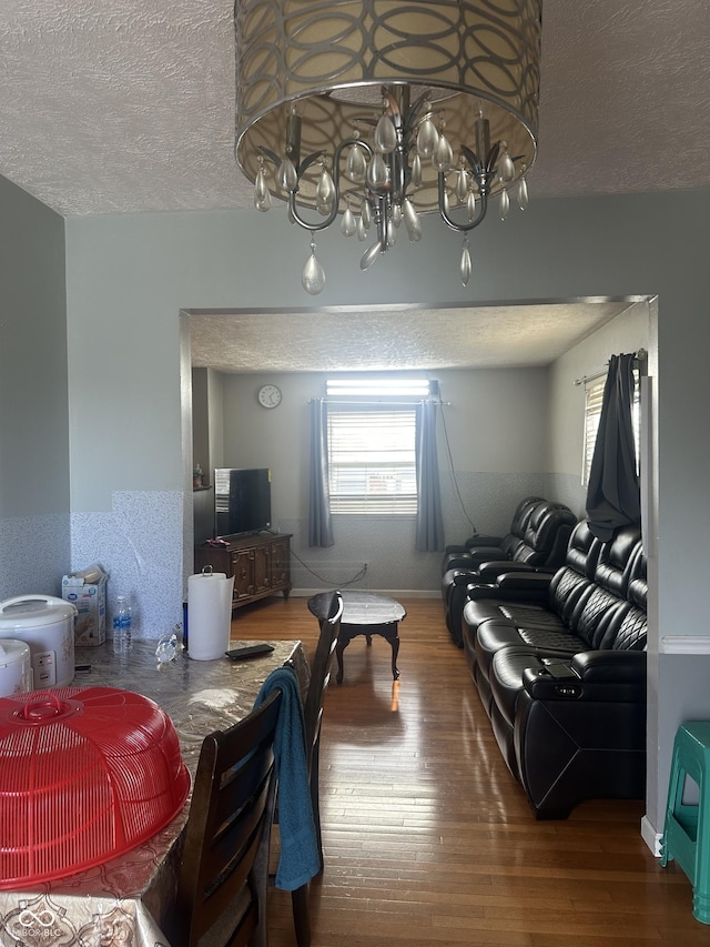4930 Candy Spots Dr, Indianapolis, IN 46237 - dining space with a textured ceiling, wood finished floors, healthy amount of natural light, and a chandelier