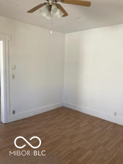 635 W Pearl St, Union City, IN 47390 - spare room with wood finished floors, a ceiling fan, and baseboards