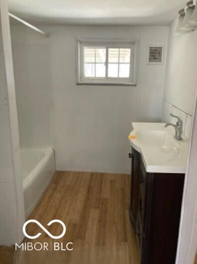 635 W Pearl St, Union City, IN 47390 - bathroom with vanity, wood finished floors, and shower / bathtub combination