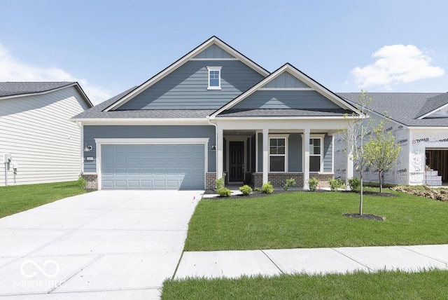 14859 Amber Light Dr, Westfield, IN 46074 - view of front of home with brick siding, a garage, concrete driveway, a front lawn, and a porch