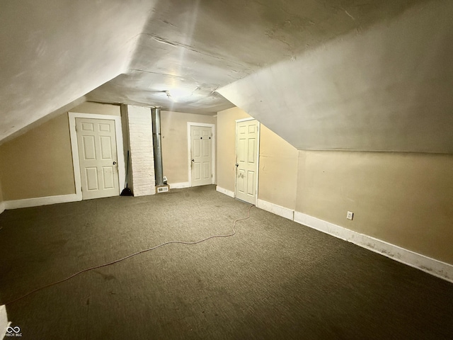 additional living space with lofted ceiling, baseboards, and carpet floors