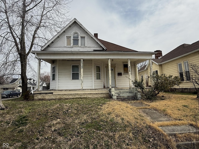 victorian house with a porch and a chimney