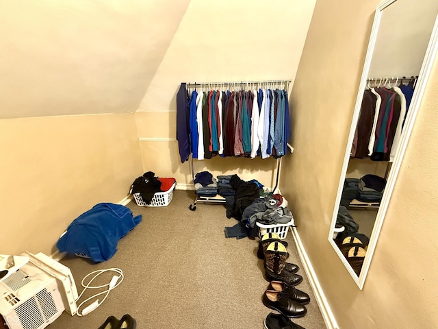 walk in closet featuring carpet floors and vaulted ceiling