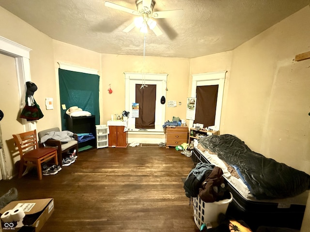 interior space featuring a textured ceiling, wood finished floors, and a ceiling fan