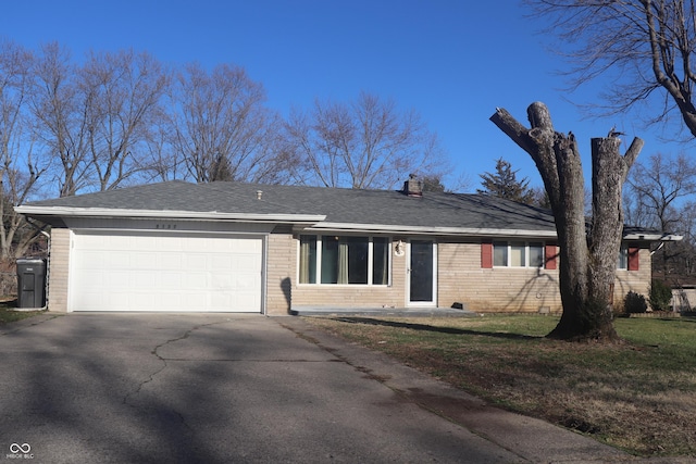 8137 S Delaware St, Indianapolis, IN 46227 - ranch-style house with a front yard, an attached garage, brick siding, and driveway