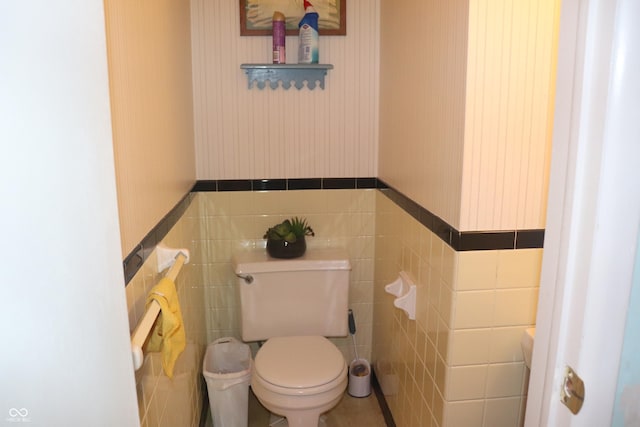 8137 S Delaware St, Indianapolis, IN 46227 - bathroom featuring wallpapered walls, tile walls, toilet, and wainscoting