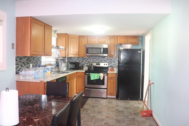 8137 S Delaware St, Indianapolis, IN 46227 - kitchen with tasteful backsplash, stone finish flooring, light countertops, black appliances, and a sink