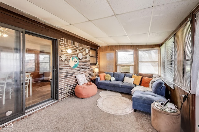 7152 Sandalwood Dr, Avon, IN 46123 - living room with wooden walls, carpet floors, brick wall, and a paneled ceiling